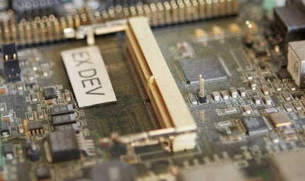 A close-up view of an embedded development board showing connectors, header pins, and surface-mounted components, emphasizing the hardware layer where IoT connectivity begins.