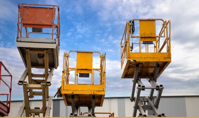 equipment rental yard showing cherry pickers
