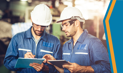 two manufacturing workers looking at notes