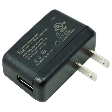 A black power supply adapter with two metal pins, featuring white printed specifications and certification logos on its top surface and USB-A connector on the side.